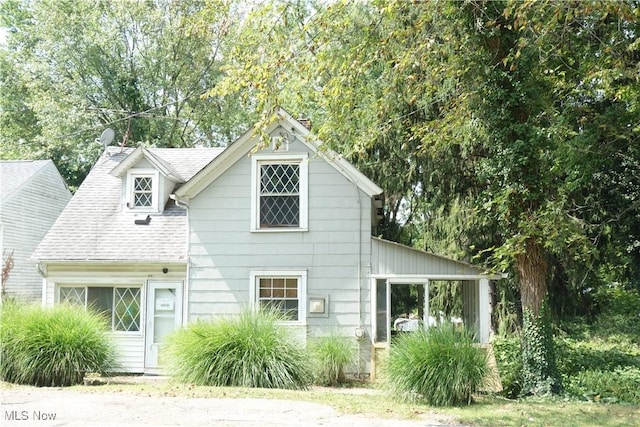 view of front of house with roof with shingles