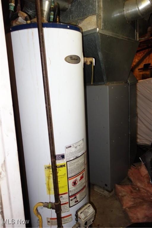 utility room with heating unit and water heater