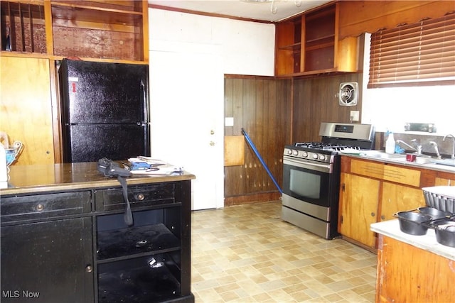 kitchen with stainless steel gas stove, visible vents, freestanding refrigerator, light countertops, and open shelves