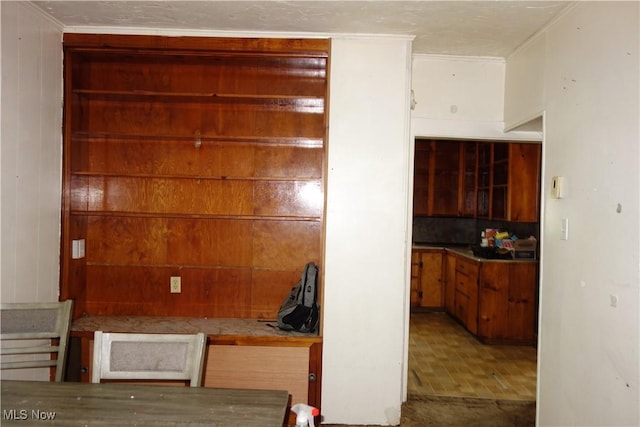 interior space featuring crown molding and wooden walls