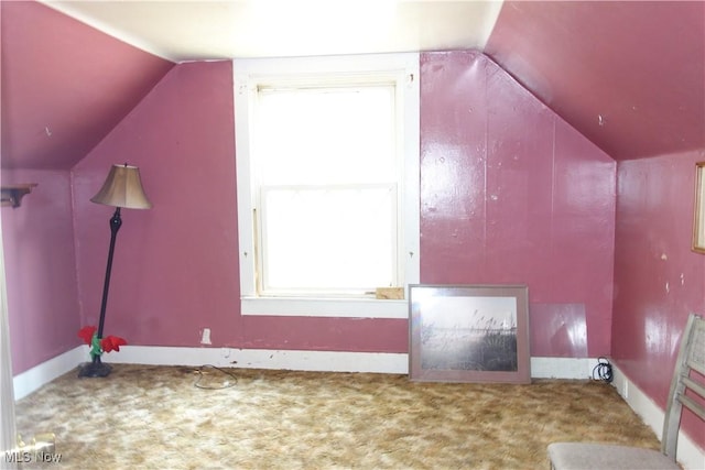 bonus room with vaulted ceiling, carpet flooring, and baseboards