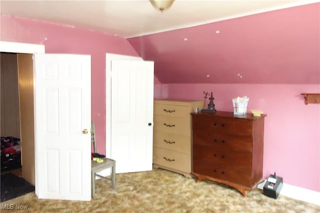 bedroom with carpet and vaulted ceiling