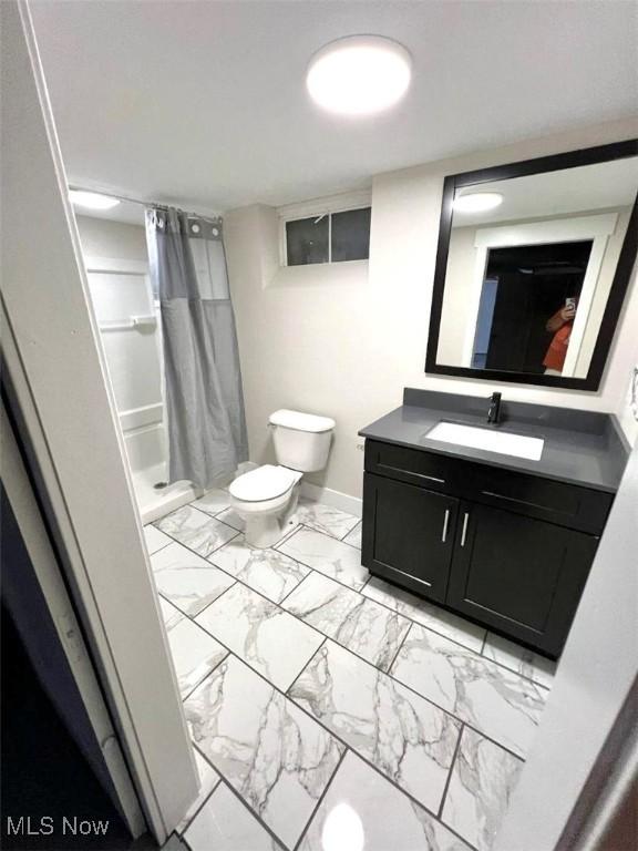 bathroom featuring toilet, tile patterned flooring, a shower with shower curtain, and vanity