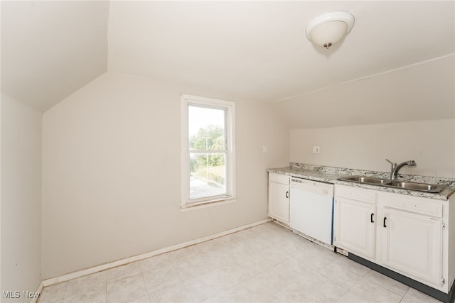 interior space with light tile patterned floors, vaulted ceiling, sink, and dishwasher