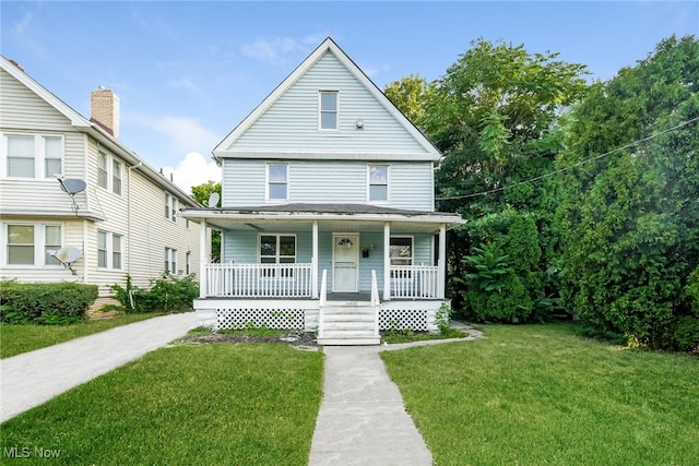 view of front of home with covered porch and a front yard