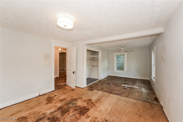 interior space with ceiling fan, hardwood / wood-style floors, and a textured ceiling