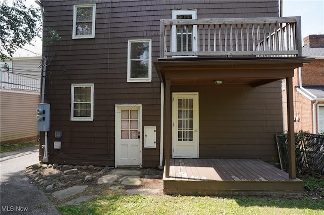 back of house featuring a deck and a balcony