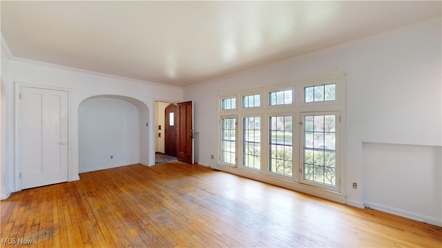 unfurnished room featuring light wood-type flooring and ornamental molding