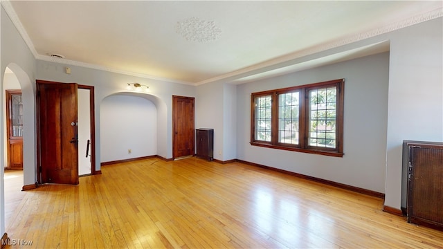 interior space featuring light wood-type flooring, crown molding, and radiator