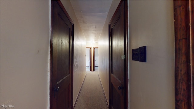 hallway featuring light colored carpet