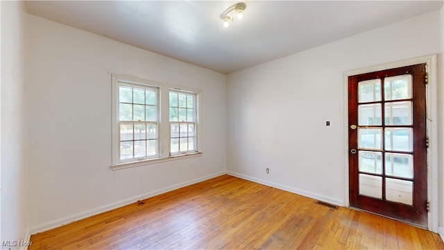 spare room with light wood-type flooring