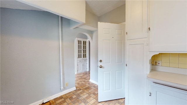 kitchen featuring white cabinets and light tile patterned flooring