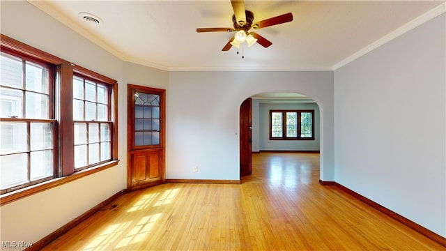 unfurnished room featuring ceiling fan, light wood-type flooring, and ornamental molding