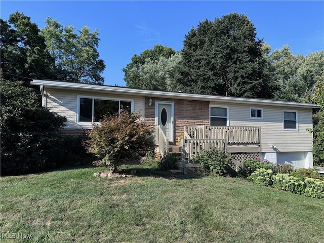 view of front of house with a deck and a front yard