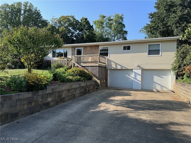 view of front facade with concrete driveway and a garage