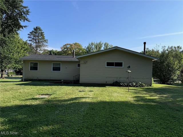 back of house with a yard