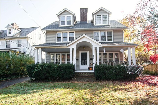 view of front of home with covered porch and a front yard