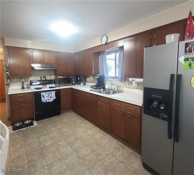 kitchen featuring appliances with stainless steel finishes, light tile patterned floors, and sink