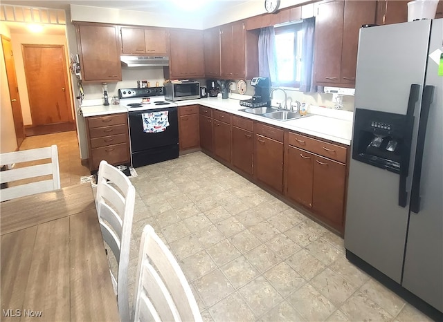 kitchen featuring appliances with stainless steel finishes, light hardwood / wood-style flooring, and sink