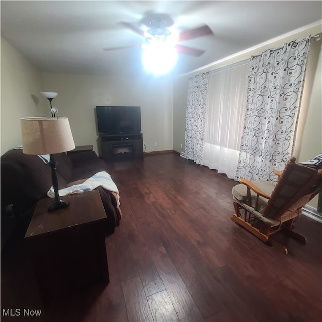 living room with ceiling fan and dark hardwood / wood-style floors