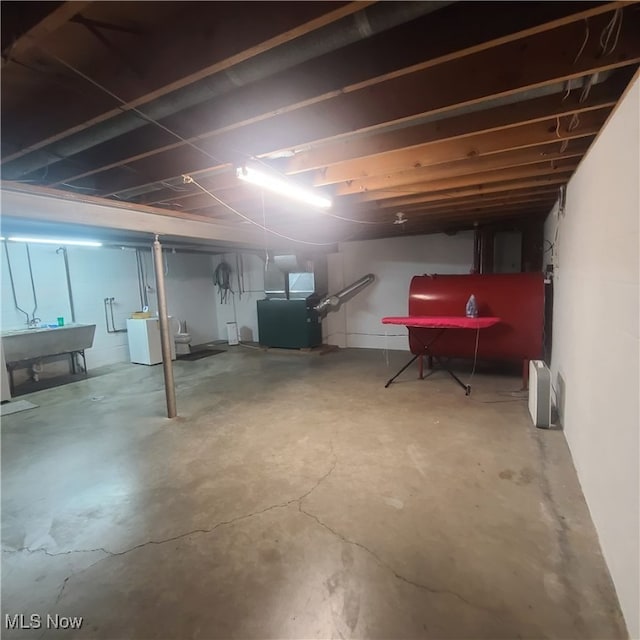 basement featuring washer / dryer and sink