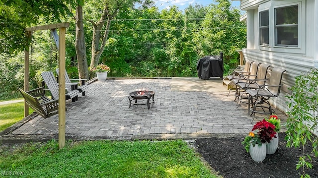 view of patio featuring grilling area and an outdoor fire pit