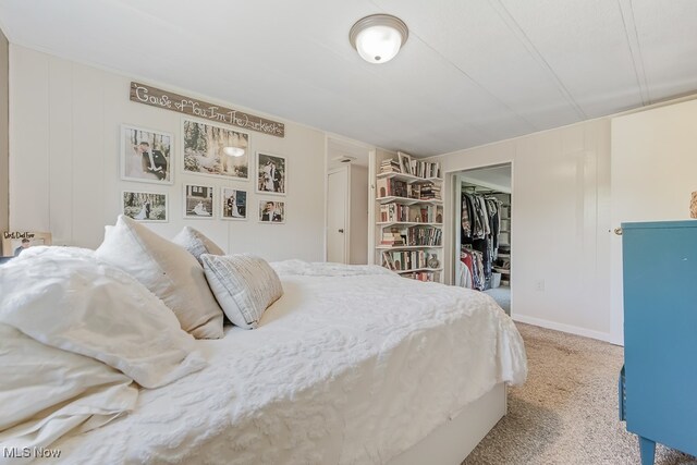 carpeted bedroom featuring a closet and a walk in closet