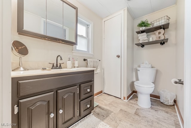 bathroom featuring vanity, toilet, and lofted ceiling