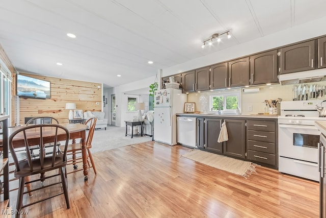 kitchen featuring rail lighting, white appliances, light colored carpet, and dark brown cabinetry