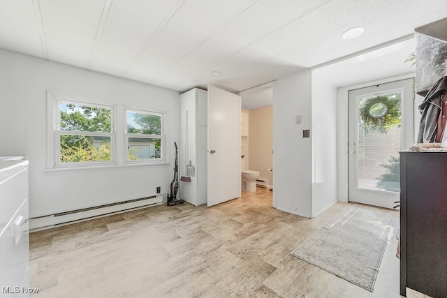 interior space with a baseboard heating unit and a healthy amount of sunlight