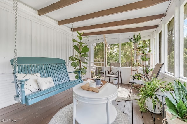 sunroom / solarium featuring beamed ceiling