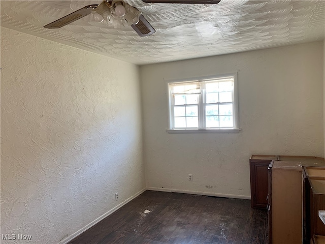 unfurnished room with ceiling fan, a textured ceiling, and dark hardwood / wood-style flooring