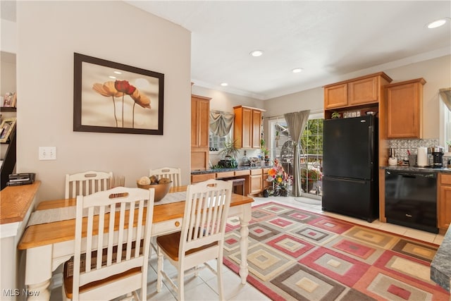 tiled dining area featuring crown molding