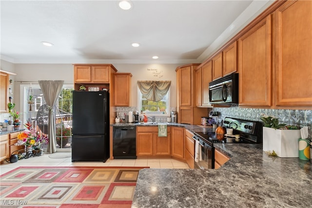 kitchen featuring a wealth of natural light, black appliances, decorative backsplash, and light tile patterned flooring