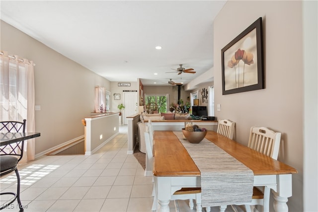 tiled dining space with ceiling fan