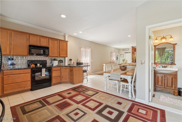 kitchen with black appliances, backsplash, and light tile patterned flooring