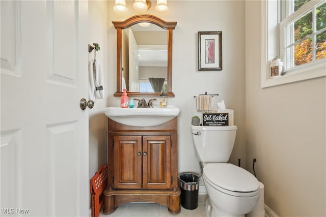 bathroom with vanity, toilet, and tile patterned flooring