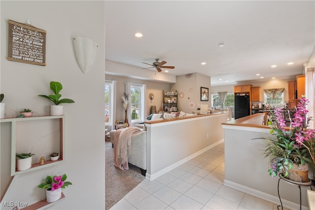 living room with ceiling fan and light tile patterned floors