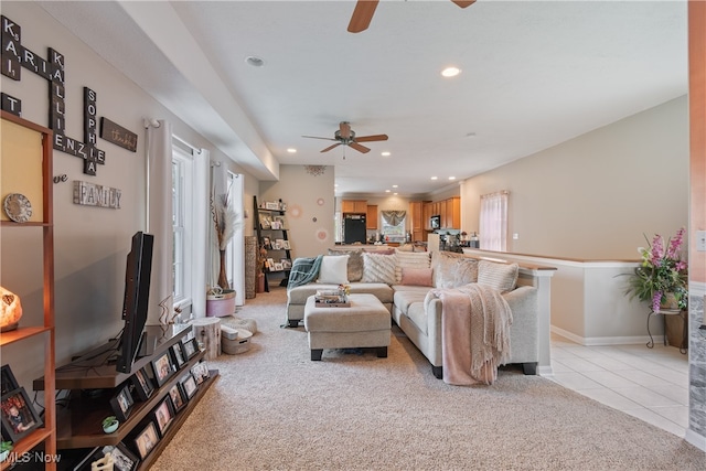 carpeted living room featuring ceiling fan