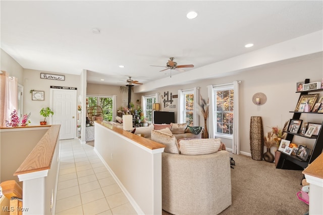 carpeted living room featuring ceiling fan