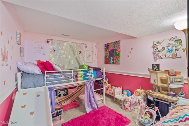 carpeted bedroom with a textured ceiling