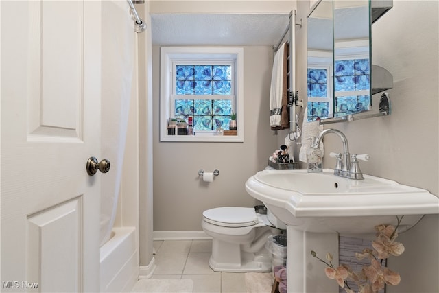 bathroom featuring shower / bath combination with curtain, tile patterned flooring, and toilet