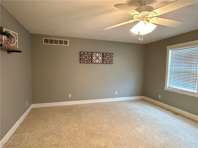 spare room with ceiling fan and carpet flooring