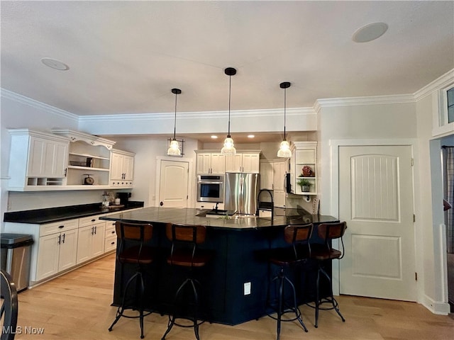 kitchen with crown molding, white cabinetry, light hardwood / wood-style flooring, a kitchen breakfast bar, and appliances with stainless steel finishes