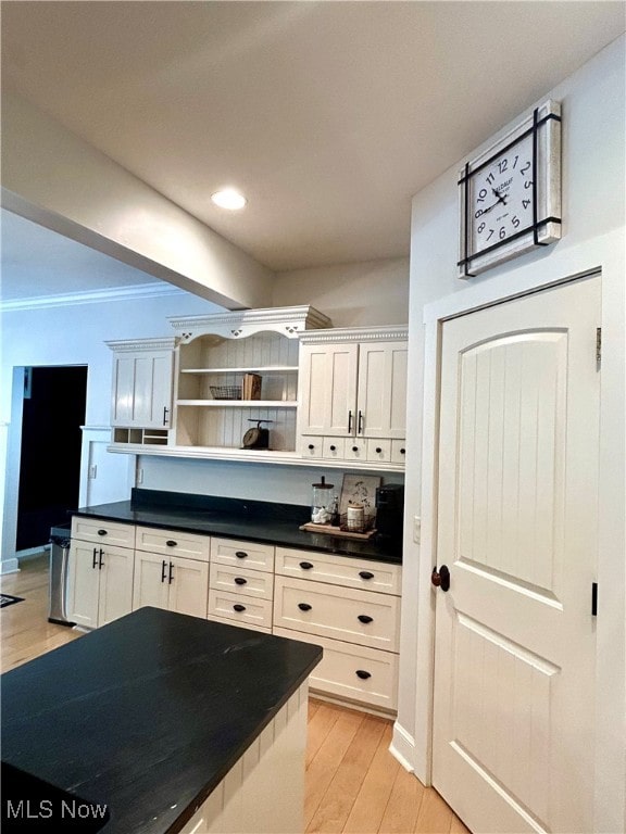 kitchen with light wood-type flooring and white cabinets