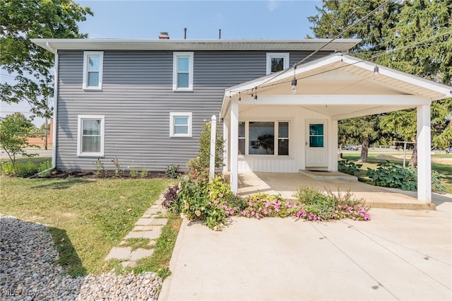 rear view of property with a yard and a patio