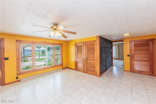 spare room featuring ceiling fan and a baseboard radiator