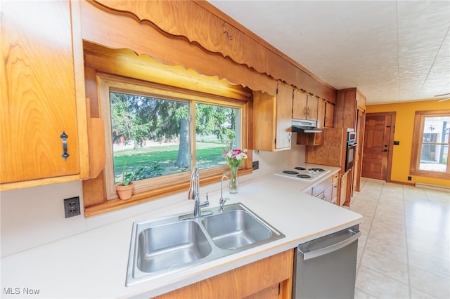 kitchen featuring stainless steel appliances, sink, a wealth of natural light, and light tile patterned flooring