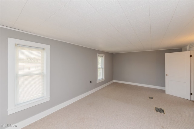 carpeted empty room with a wealth of natural light