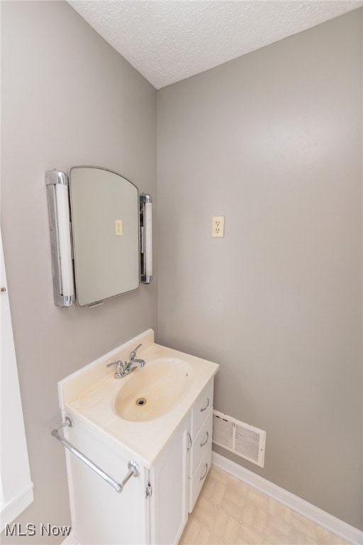 bathroom featuring vanity and a textured ceiling